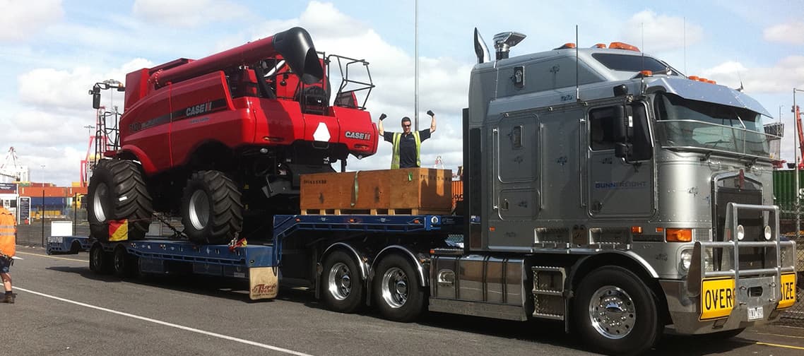 Prime mover carrying two tractors